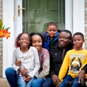 family portrait in front of house