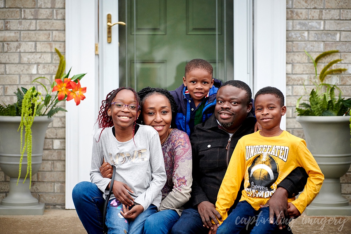 family portrait in front of house