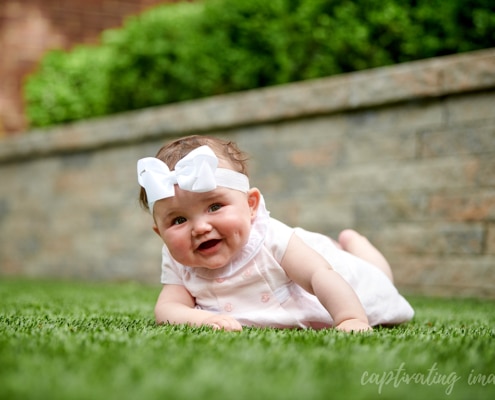 baby girl tummy time on grass