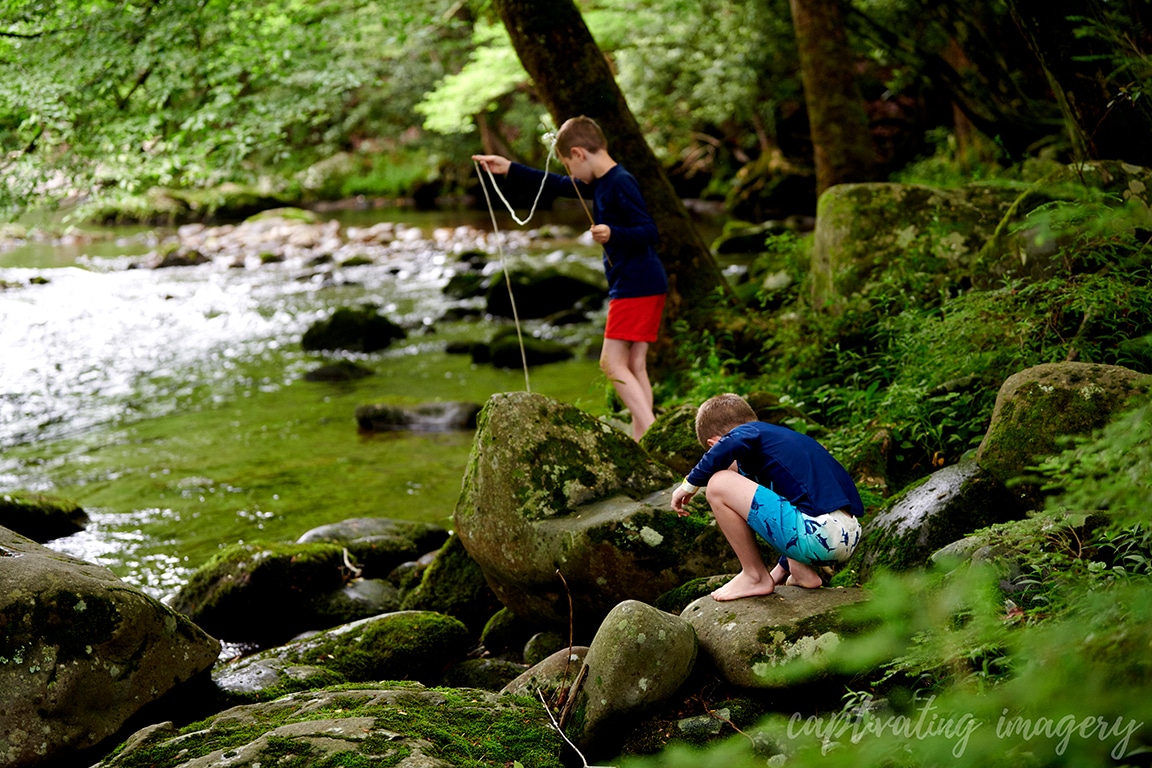 boys playing in creek