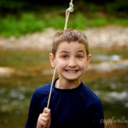 boy smiling with creek in background