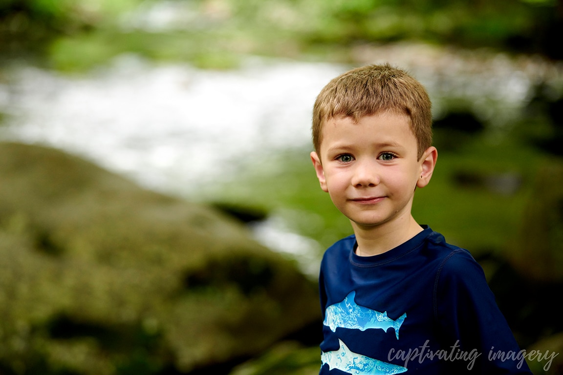 boy with creek in background