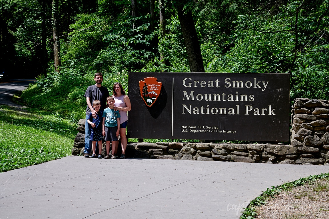 family portrait by national park sign