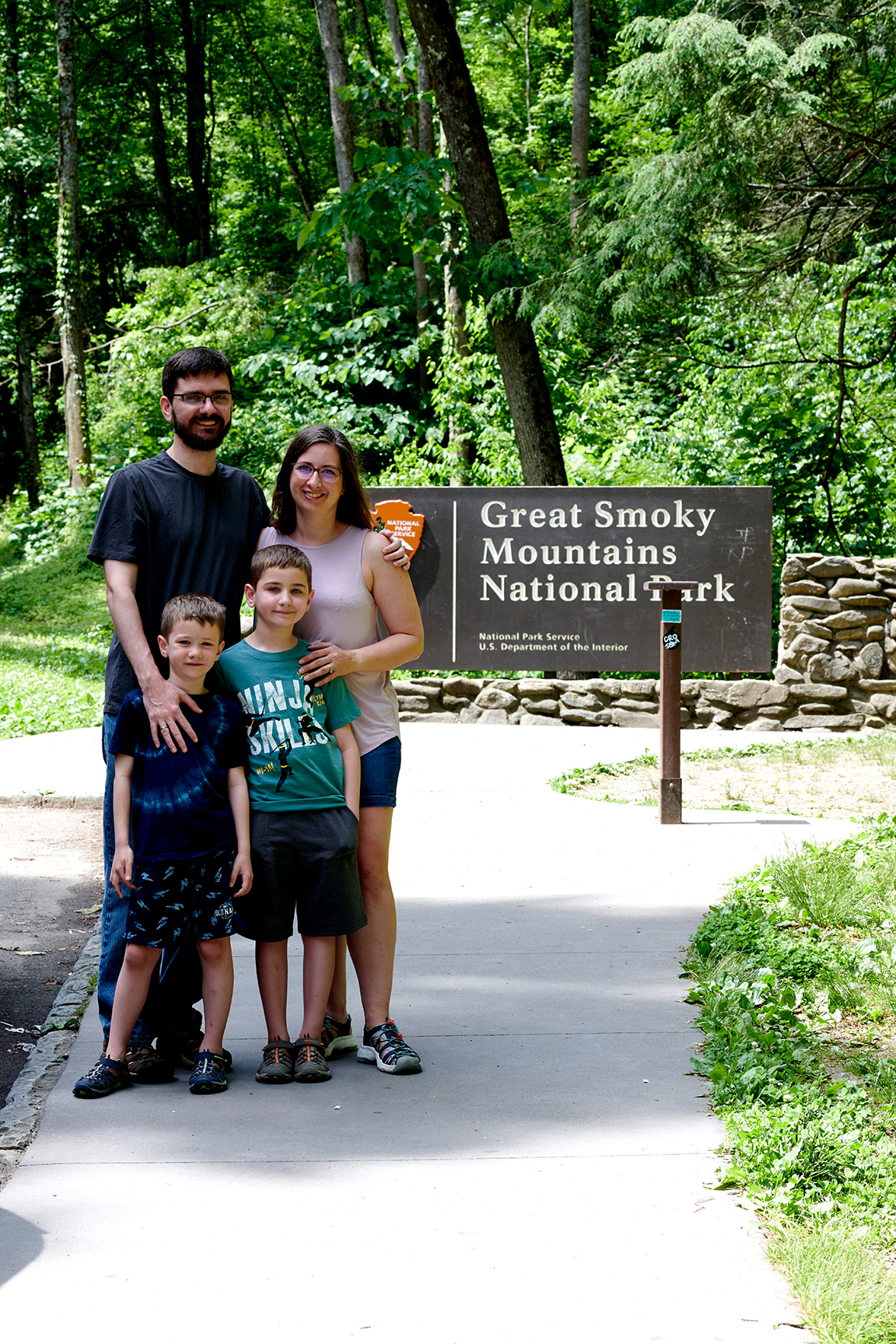 family portrait by national park sign