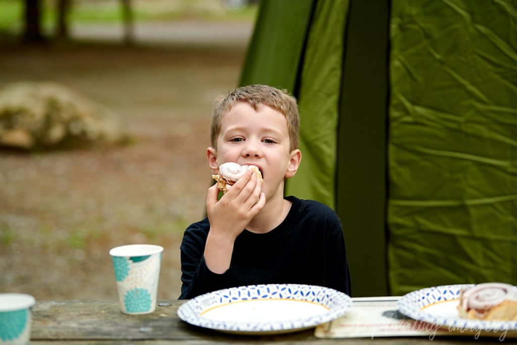 boy eats cinnamon roll