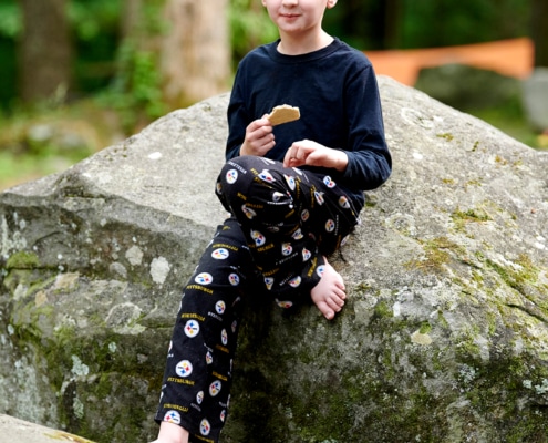 boys play on boulders