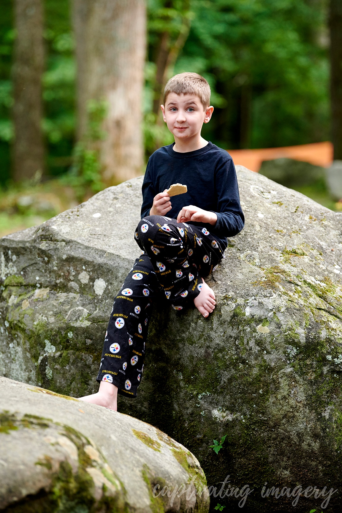 boys play on boulders