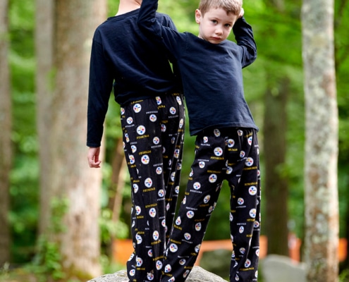 boys play on boulders