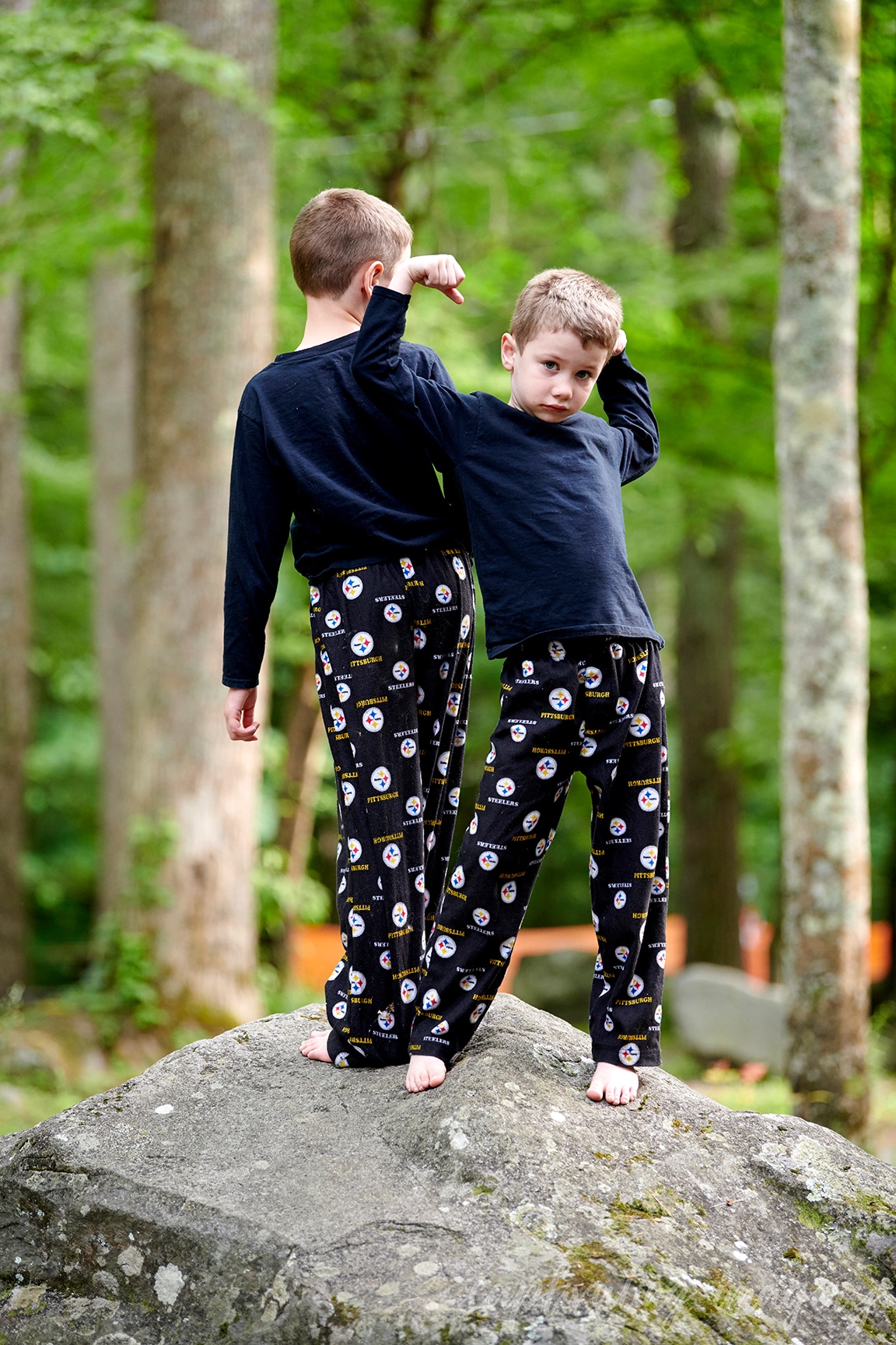 boys play on boulders