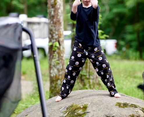 boys play on boulders