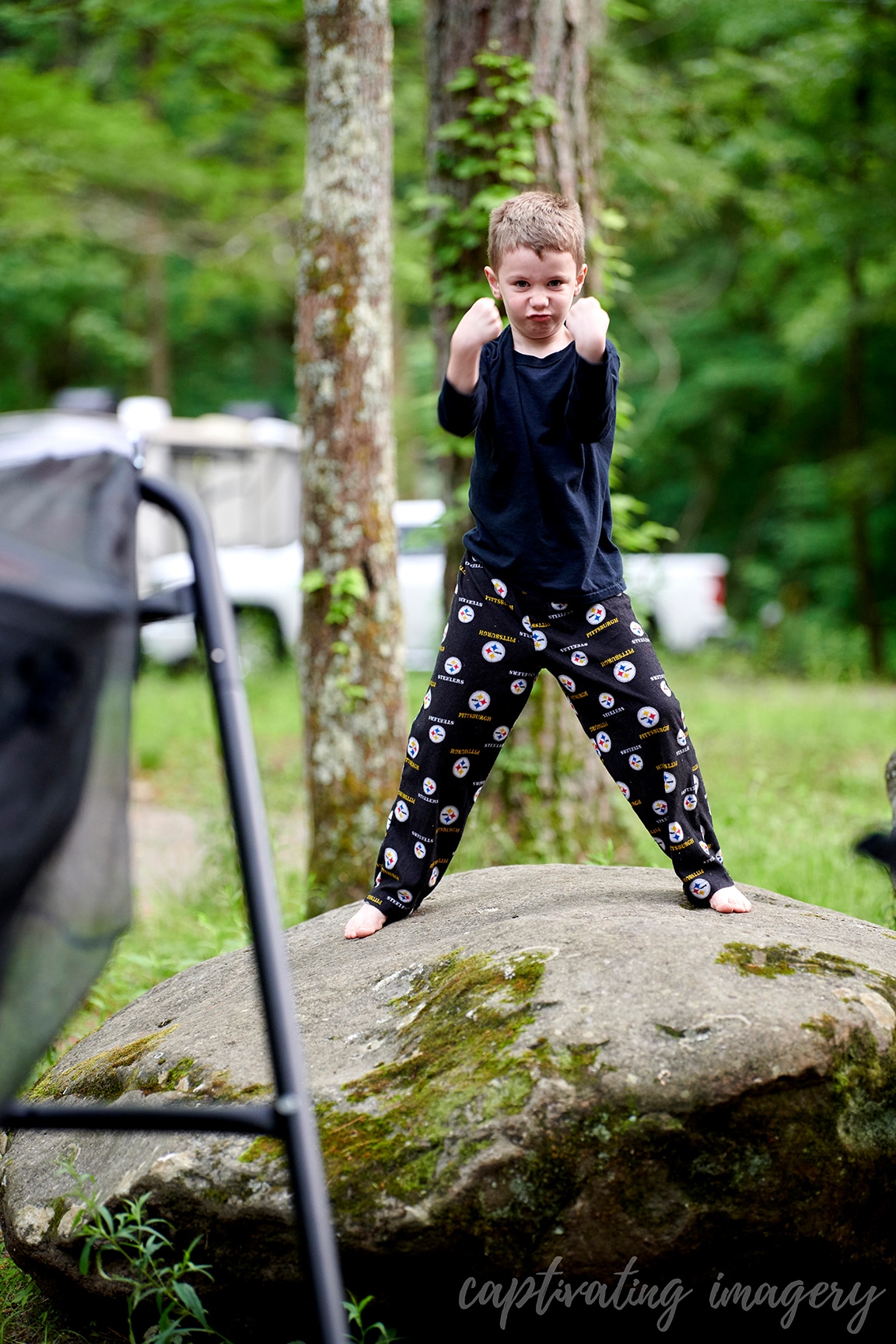 boys play on boulders