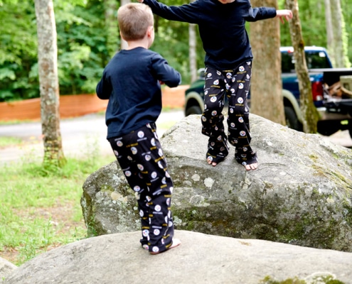 boys play on boulders