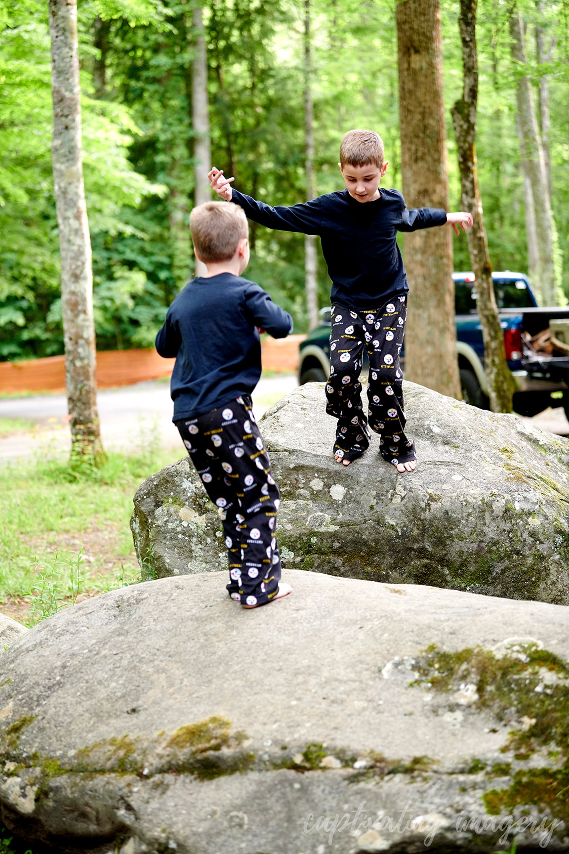 boys play on boulders