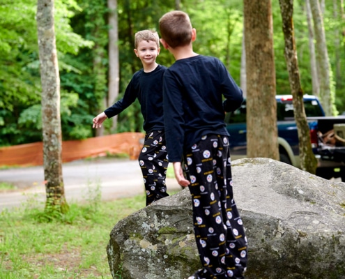 boys play on boulders