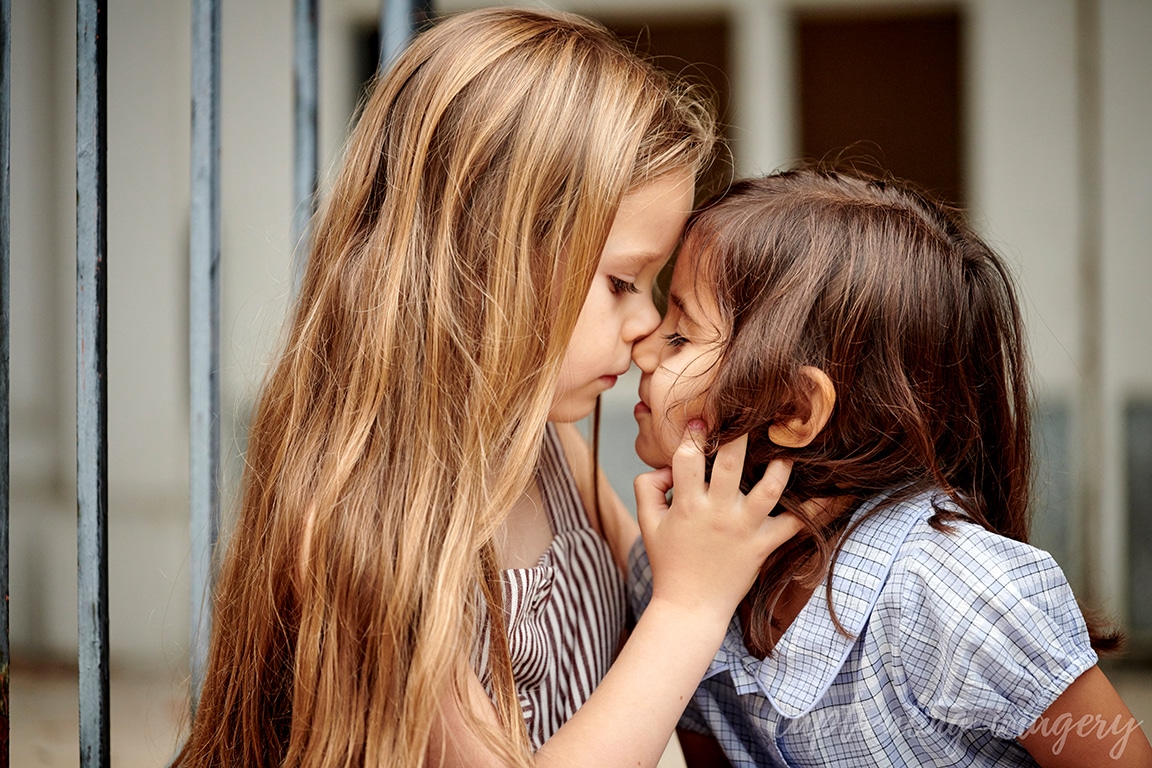 Sisters touch foreheads