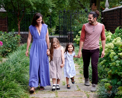 Parents and daughters walk in garden