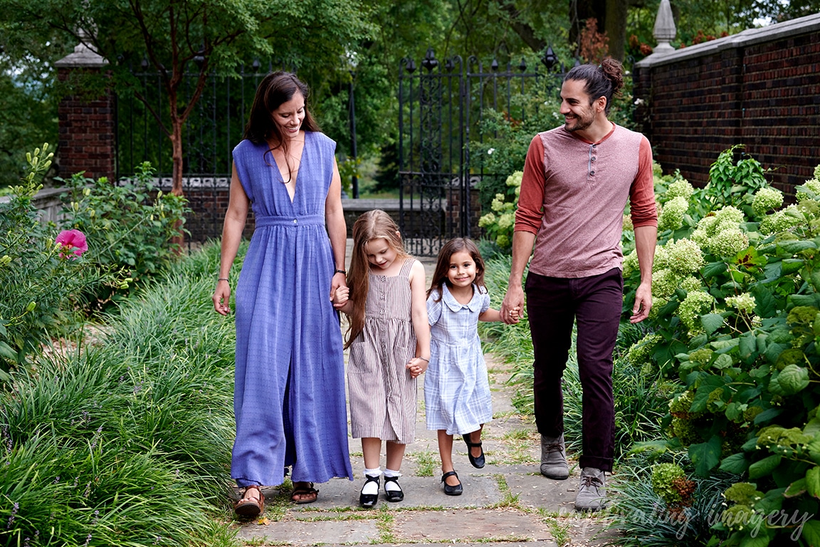 Parents and daughters walk in garden